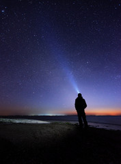 Lonely man at the beach under the stary sky