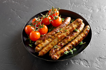 Roasted sausages and cherry tomatoes