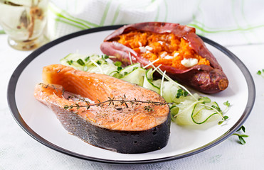 Healthy food: baked salmon and sweet potato and vegetables. Diet menu.