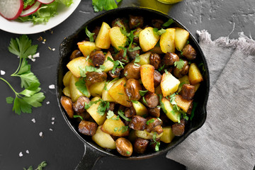 Fried potatoes with mushroom and sausage