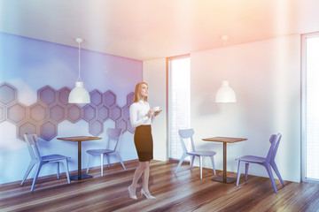 Blonde woman in white and blue cafe