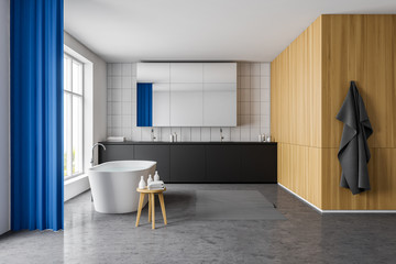 Bright white and wooden bathroom with blue curtain