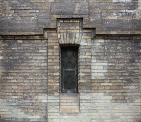 Old brick wall and small window