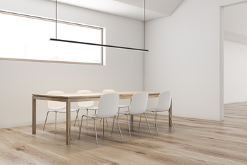 Attic white dining room corner with long table