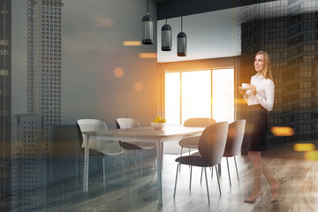Fototapeta premium Blonde woman in gray dining room corner