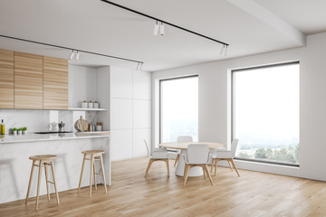 Loft white kitchen with bar and table