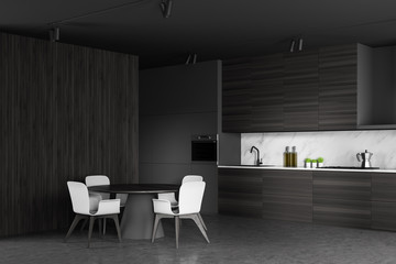 Gray and wooden kitchen corner with round table