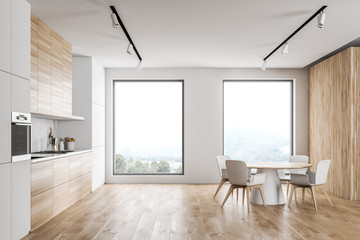 Stylish white and wooden kitchen with dining table