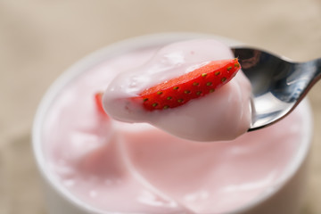 eat strawberry yogurt in white bowl closeup shot