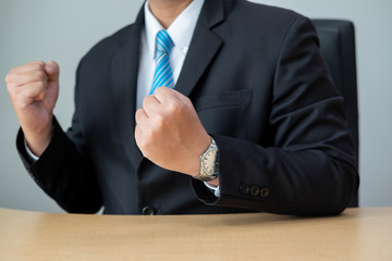 Business people wear suits and blue tie.Businessman show hand with confidence at desk.