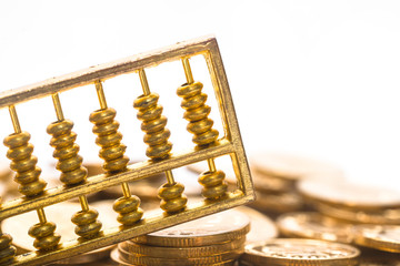 A gold abacus was placed on the background of the pile of COINS
