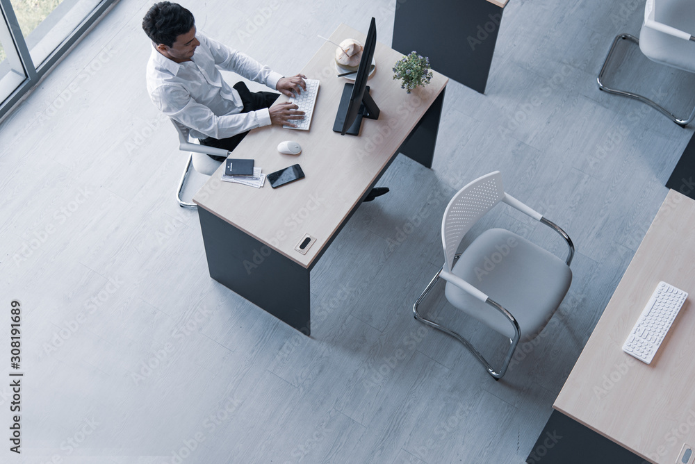 Poster top view of executive, manager, or engineer drinking coconut juice working on computer sitting in cr