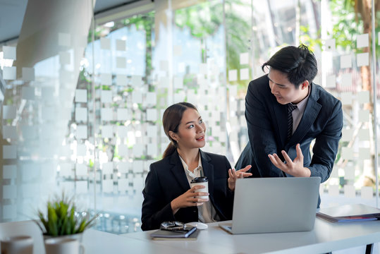 Modern Business People Discussing Work In Office And Using Laptop Together While Working.