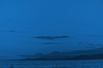 classic blue Pantone 2020 color .sky and mountain silhouettes on the horizon . space for text . background image