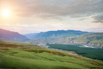 Beautiful landscape of village in valley with forest and river in the morning sunrise