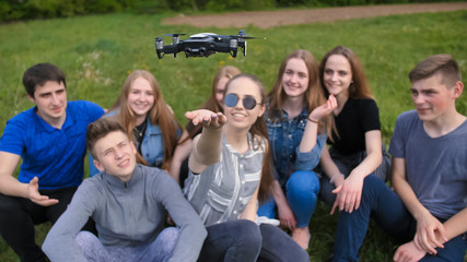 Happy cheerfulfriends launch a drone from their hands.