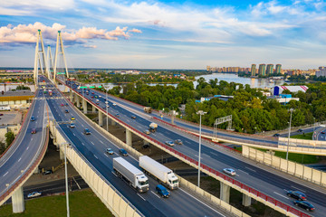 Fototapeta premium Saint Petersburg. Russia. Highway in St. Petersburg. Trucks are driving on the freeway. Concept - cargo transportation to Petersburg. The bridge across the Neva. Roads of Russia. Express road.