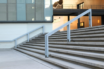 Stairs and handrails to the front of the building. Stairs and handrails made of steel.