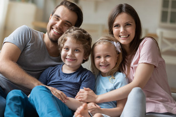 Beautiful parents embrace son and daughter showing protection and love