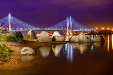Obraz premium Saint Petersburg. Russia. Neva coast. Big Obukhov bridge. Stones on banks of the Neva. Night Petersburg. Cable-stayed bridge. Tours on the canals of St. Petersburg. City landscape. Cities of Russia