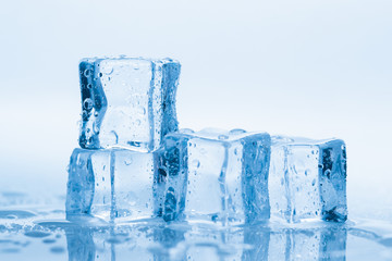 Ice cubes square with drops water clean on blue background