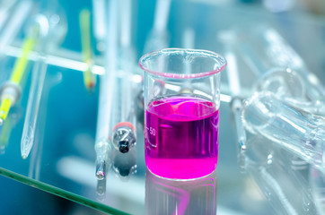 Close-up of Glass Flask with reagents, laboratory equipments.
