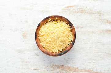 Grated Parmesan cheese in a bowl. Top view. Free space for your text.