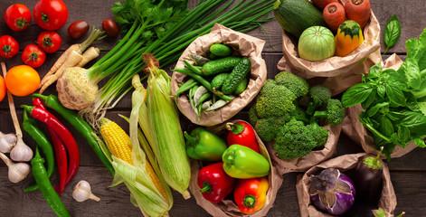 Healthy background with fresh different vegetables in reusable paper bags