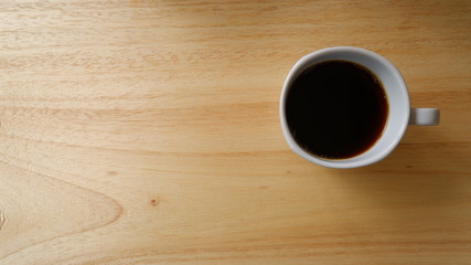 cup of coffee on wooden table
