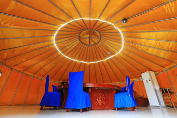 The table and chair are in the yurt.
