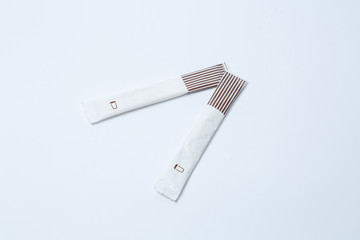 Two sticks of sugar on a white background