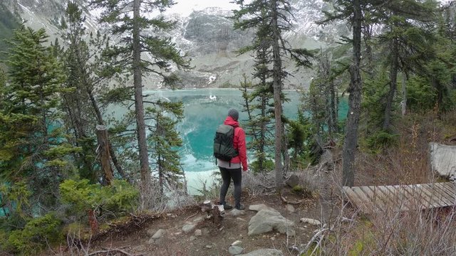 Woman Hiking Beside Glacial Lake