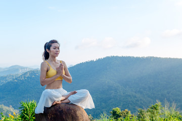 Asian woman doing exercise yoga. sitting in Sukhasana exercise, Easy Seat pose pose. Amazing yoga...