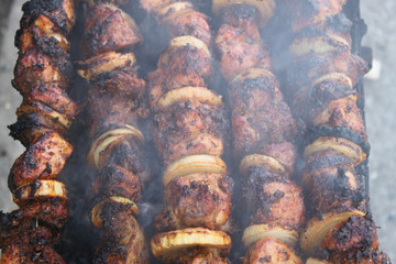 Rosy juicy kebab is fried on the grill, background, wallpaper