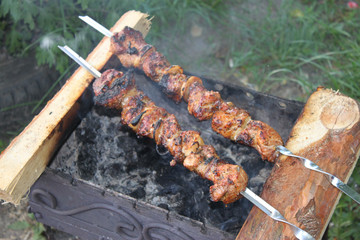Rosy juicy kebab is fried on the grill, background, wallpaper