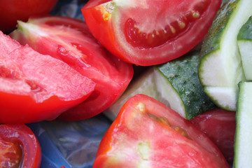 Sliced ​​vegetables cucumbers and tomatoes close-up, background, wallpaper