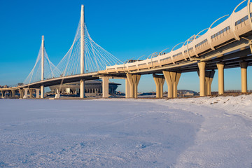 Saint Petersburg. Russia. Bridges Of St. Petersburg. Rivers Of St. Petersburg. The highway passes over the bridge. The cable-stayed Obukhovsky bridge. The Neva river is frozen. Car traffic.