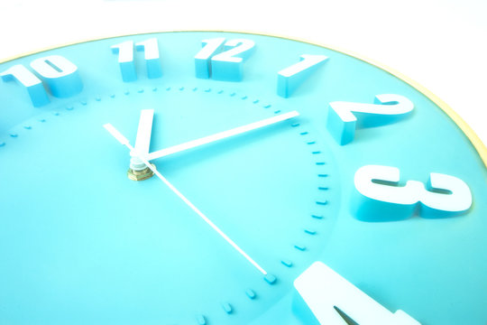 Close Up Of A Blue Clock Face With 3D Numbers And Second Hand