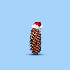 Christmas cone in a hat of Santa Claus on a blue background. Isolated.