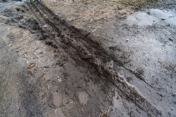 Mud with a puddle on an impassable road