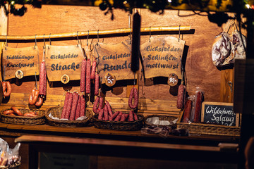 various hanging salami sausages at burcher TRANSLATION FROM GERMAN different FANTASY SAUSAGES
