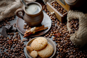 Coffee in a cup and saucer on an old background.