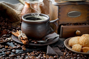 Coffee in a cup and saucer on an old background.