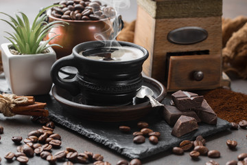 Coffee in a cup on a background of coffee beans, on an old background.