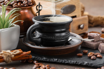 Coffee in a cup and saucer on an old background.