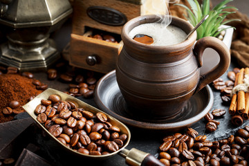 Coffee beans are roasted in a pan with smoke.