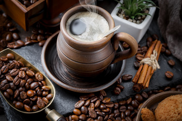 Coffee beans are roasted in a pan with smoke.