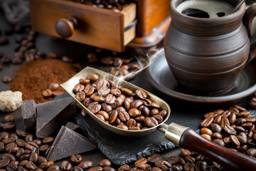 Coffee in a cup on a background of coffee beans, on an old background.