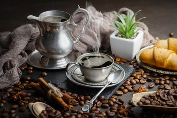Coffee beans are roasted in a pan with smoke.