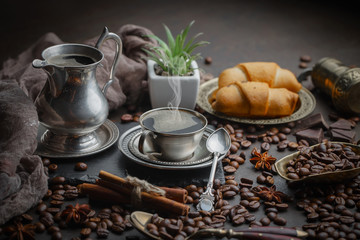 Coffee in a cup and saucer on an old background.